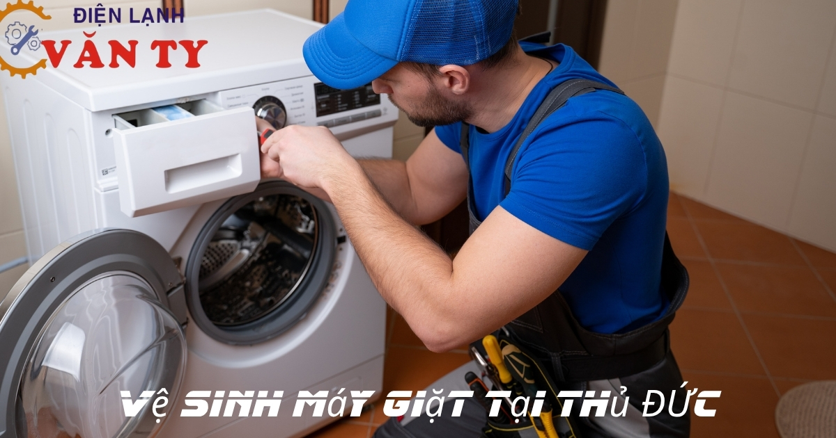 a man in a blue hat working on a washing machine